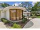 Curved window front of one-story home with lush landscaping at 10265 130Th St, Largo, FL 33774