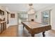 Game room showcasing a pool table, overhead lighting, and natural light from the window at 10265 130Th St, Largo, FL 33774
