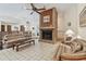 Comfortable living room featuring a brick fireplace, neutral decor, and tile flooring at 10265 130Th St, Largo, FL 33774