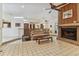 Open-concept living room features a brick fireplace, ceiling fan, and access to other living areas at 10265 130Th St, Largo, FL 33774