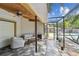 Relaxing screened patio with comfortable seating and view of the pool and backyard at 10265 130Th St, Largo, FL 33774