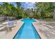 Beautiful in-ground pool with pristine water, surrounded by mature trees and landscaping at 10265 130Th St, Largo, FL 33774