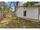 Side yard showing the home's siding, and a wooden fence line at 10265 130Th St, Largo, FL 33774