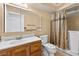 Bathroom featuring a vanity with drawers and cabinets, mirror, toilet and shower with curtain rod at 11001 Ridgedale Rd, Temple Terrace, FL 33617