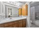 Functional bathroom with a vanity, white countertop, and a shower with a patterned curtain at 11001 Ridgedale Rd, Temple Terrace, FL 33617