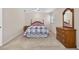 Comfortable bedroom with neutral walls, soft carpet, and a classic wooden dresser at 11001 Ridgedale Rd, Temple Terrace, FL 33617