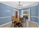 Charming dining room featuring classic wainscoting, bright windows, and traditional furniture at 11001 Ridgedale Rd, Temple Terrace, FL 33617
