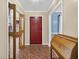 Inviting foyer features unique tile flooring and a classic wooden writing desk at 11001 Ridgedale Rd, Temple Terrace, FL 33617