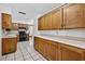 Well-lit kitchen featuring wooden cabinets, white countertops, and modern appliances at 11001 Ridgedale Rd, Temple Terrace, FL 33617