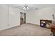 Open living room with view of another room, carpet flooring, hanging light fixture, and vintage side table at 11001 Ridgedale Rd, Temple Terrace, FL 33617