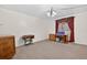 Spacious living room featuring classic crown molding, a sewing table, and red-patterned curtains at 11001 Ridgedale Rd, Temple Terrace, FL 33617