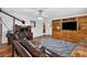Spacious living room with hardwood floors, built in shelves and television at 11001 Ridgedale Rd, Temple Terrace, FL 33617