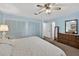 Spacious bedroom with a ceiling fan, neutral walls, and ample closet space at 11001 Ridgedale Rd, Temple Terrace, FL 33617