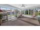 Bright sun room with floor-to-ceiling windows and outdoor views at 11001 Ridgedale Rd, Temple Terrace, FL 33617