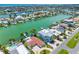 Spacious waterfront property featuring a luxurious home, a large pool, lush landscaping, and a private boat dock at 11260 7Th E St, Treasure Island, FL 33706