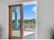 Balcony with wood-trimmed sliding glass door, a view of the canal, and the dock for easy water access at 11260 7Th E St, Treasure Island, FL 33706