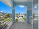 Balcony with white railings overlooks a picturesque neighborhood with lush greenery and distant waterways at 11260 7Th E St, Treasure Island, FL 33706