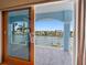 Lovely views from the balcony overlooking waterfront residences, framed by the open sliding glass doors at 11260 7Th E St, Treasure Island, FL 33706