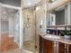 Elegant bathroom features a glass-enclosed shower with decorative tile and a vanity with granite countertop at 11260 7Th E St, Treasure Island, FL 33706