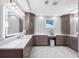Large bathroom with double vanity, marble floors, and plenty of cabinet space at 11260 7Th E St, Treasure Island, FL 33706