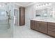 Bathroom featuring a walk-in shower, double sink vanity, and access to a walk-in closet at 11260 7Th E St, Treasure Island, FL 33706