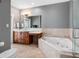 Bathroom with soaking tub, vanity with makeup counter, and glass shower at 11260 7Th E St, Treasure Island, FL 33706