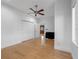 Cozy bedroom with hardwood floors, ample natural light, a modern ceiling fan, and double door closet at 11260 7Th E St, Treasure Island, FL 33706