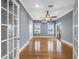 Bright room features hardwood floors, a ceiling fan, natural light, and French doors leading to an outdoor balcony at 11260 7Th E St, Treasure Island, FL 33706