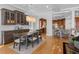 Elegant dining room featuring hardwood floors, built-in cabinets, and a view into the kitchen at 11260 7Th E St, Treasure Island, FL 33706