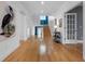 Bright entryway featuring hardwood floors, a grand staircase, and stylish decor, creating a welcoming ambiance at 11260 7Th E St, Treasure Island, FL 33706