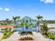 Charming coastal home with a well-manicured lawn, beautiful landscaping, and a three-car garage at 11260 7Th E St, Treasure Island, FL 33706