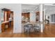 Open kitchen with granite countertops, stainless steel appliances, breakfast bar, and hardwood floors at 11260 7Th E St, Treasure Island, FL 33706
