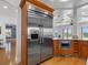 Kitchen featuring a stainless steel refrigerator, custom cabinetry, and a convenient built-in microwave at 11260 7Th E St, Treasure Island, FL 33706
