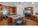 Gourmet kitchen featuring stainless steel appliances, granite countertops, custom cabinetry, and a center island at 11260 7Th E St, Treasure Island, FL 33706