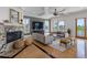 Cozy living room showcasing a marble fireplace, hardwood floors, and ample seating at 11260 7Th E St, Treasure Island, FL 33706