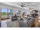 Open living room with stylish furnishings, waterfront views, and elegant ceiling details at 11260 7Th E St, Treasure Island, FL 33706
