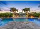 Beautiful pool area with pavers, lush landscaping, and water views creating a serene backyard retreat at 11260 7Th E St, Treasure Island, FL 33706