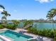 Backyard featuring a private pool, dock, and waterfront views at 11260 7Th E St, Treasure Island, FL 33706