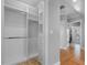 Walk-in closet with custom shelving and hanging racks at 11260 7Th E St, Treasure Island, FL 33706
