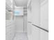 Bright walk-in closet features custom shelves, drawers, and marble floors, offering stylish and ample storage at 11260 7Th E St, Treasure Island, FL 33706