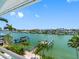 Enjoy the beautiful water views with boat docks, palm trees, and neighboring homes from your own balcony at 11260 7Th E St, Treasure Island, FL 33706