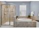 The elegant bathroom features a separate shower and a luxurious soaking tub for ultimate relaxation at 11325 78Th E St, Parrish, FL 34219