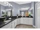 A bathroom features dual sinks, granite countertops, and ample storage space at 11325 78Th E St, Parrish, FL 34219