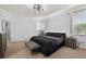 A bedroom features a ceiling fan, natural light, and a dark-colored bed at 11325 78Th E St, Parrish, FL 34219