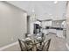 Open floor plan with dining area leading to the kitchen featuring white cabinets at 11325 78Th E St, Parrish, FL 34219