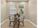 Bright dining room with contemporary light fixture and natural light coming from the window at 11325 78Th E St, Parrish, FL 34219