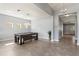 Open-concept game room featuring a pool table, modern lighting, and access to the hallway at 11325 78Th E St, Parrish, FL 34219