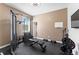 Home gym includes universal weight machine, bench, dumbbells, and floor mats, perfect for fitness enthusiasts at 11325 78Th E St, Parrish, FL 34219