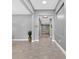 Bright hallway features sleek grey tile flooring and leads to other rooms at 11325 78Th E St, Parrish, FL 34219