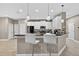 Bright kitchen featuring white cabinets, black countertops, stainless steel appliances, and bar seating at 11325 78Th E St, Parrish, FL 34219